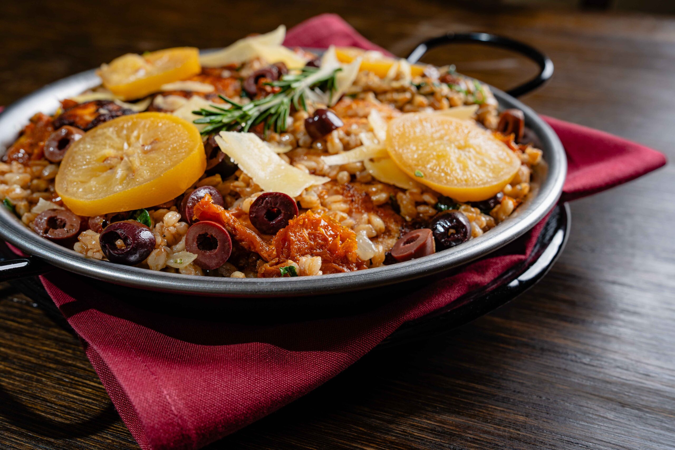 a metal bowl full of rice and vegetables,