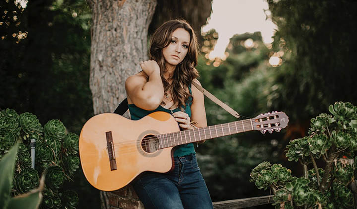 a woman holding a guitar